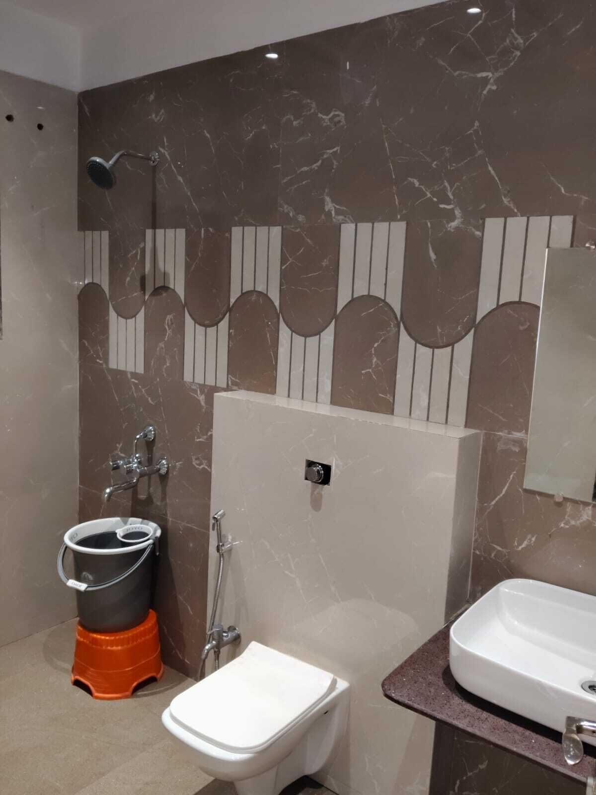 A modern bathroom with a toilet, bidet, and sink.