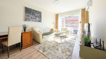 Apartment | Living area | 30-inch flat-screen TV with cable channels