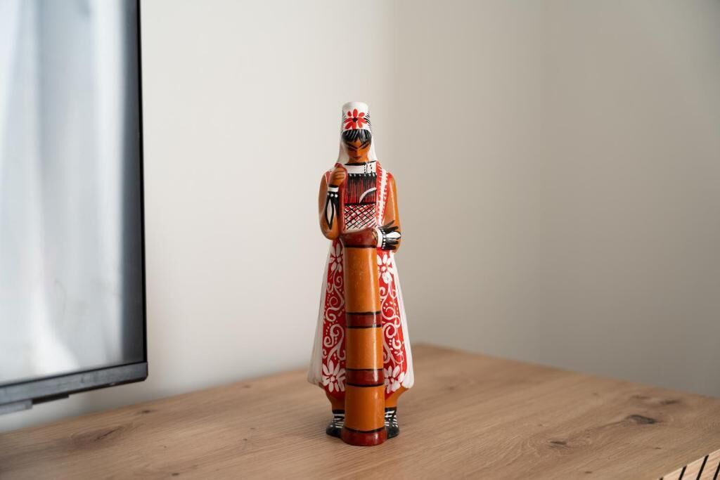 A wooden figurine on a wooden surface.
