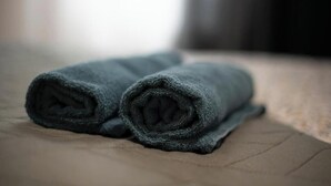 Two rolled towels on a textured surface. - Mega Cool apartment between France and Switzerland - near Basel (Saint-Louis)