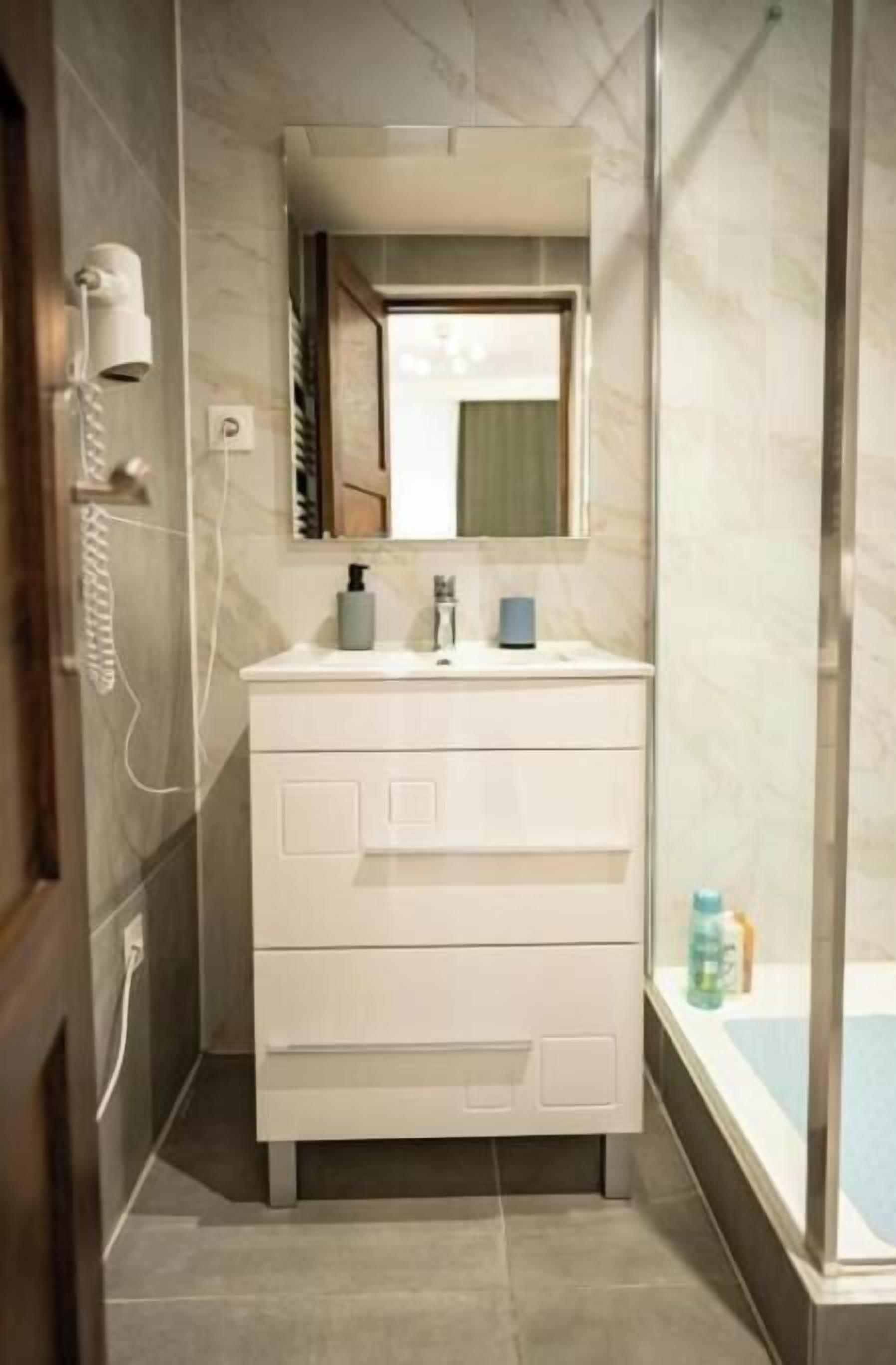 Shower, hair dryer, towels, toilet paper