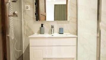 Shower, hair dryer, towels, toilet paper
