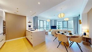 A modern hotel room with a kitchen, dining area, and large windows. - Aesthetic 1 Bed l Close to Burj Khalifa l Downtown (Downtown Dubai)