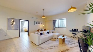 A modern living room with a sectional sofa, a coffee table, a piano, and a large window with curtains. - Sleek 1 Bedroom l Business Bay l City View (Business Bay)