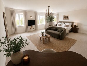 A modern bedroom with a bed, a sofa, a TV, and a chandelier. - Luxury 7 Bedroom Retreat Near Port Isaac - Sleeps 18 - Hot Tub & Games Room (Port Isaac)