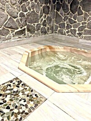 A stone wall surrounding a hot tub area with a mosaic tile floor. - 3305   The Peak of Beech Mountain: 3rd Floor Slope-View Escape (Beech Mountain)