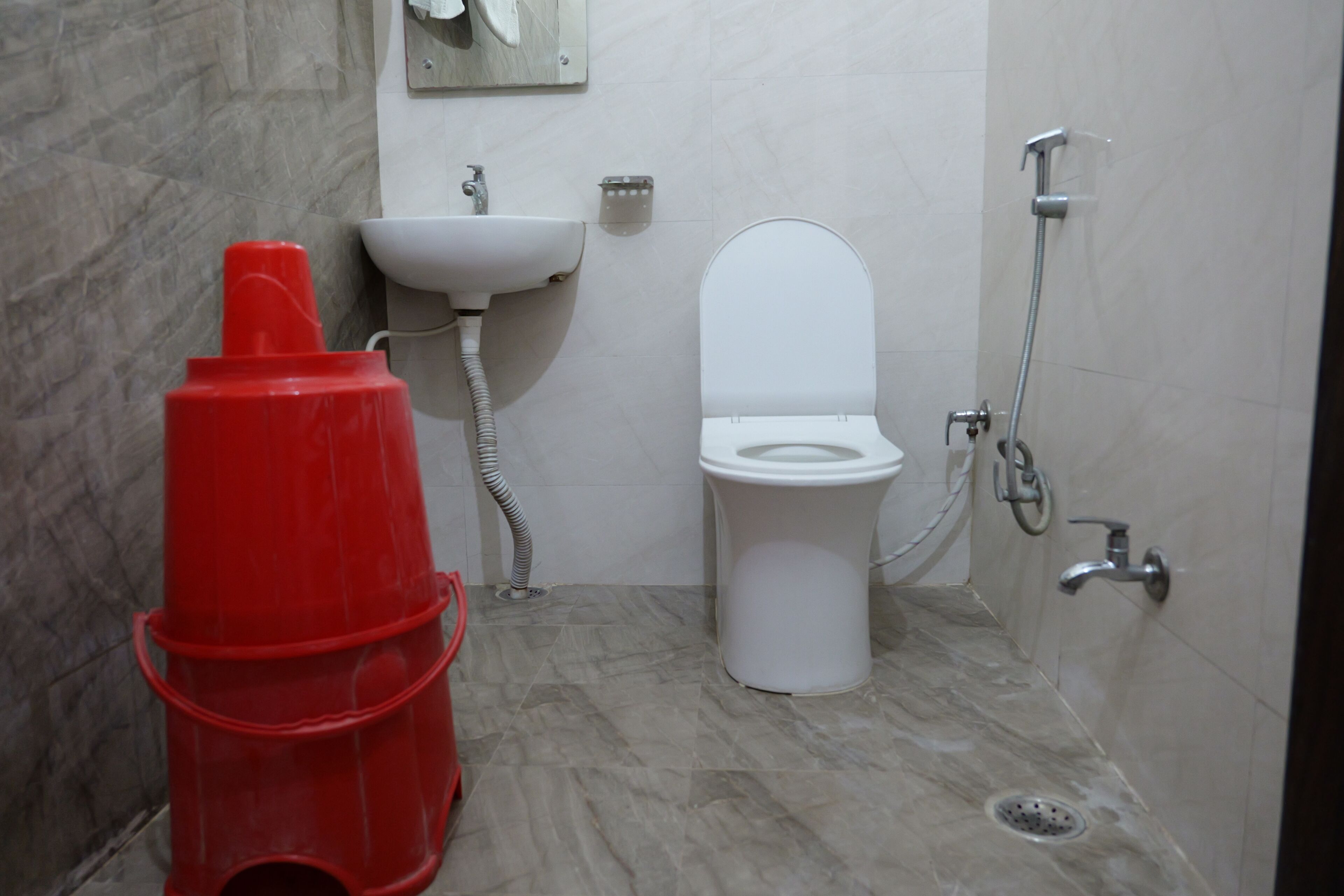 Une salle de bain avec des toilettes, un lavabo et une douche.