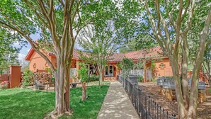 A residential property with a paved pathway, a fenced garden, and a house with a red-tiled roof. - Private Hot Tub, Firepit & Duck Pond Near Canyon Lake + Whitewater Amphitheater (Canyon Lake)