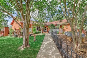 A residential property with a paved pathway, a fenced garden, and a house with a red-tiled roof. - Private Hot Tub, Firepit & Duck Pond Near Canyon Lake + Whitewater Amphitheater (Canyon Lake)