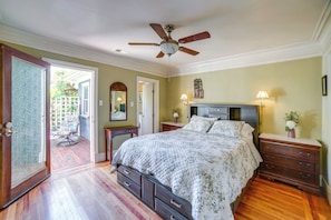 A bedroom with a bed, dresser, nightstand, ceiling fan, and a door leading to a patio. - Charming Sonoma Wine Country Home Base w/ Extras (Cloverdale)