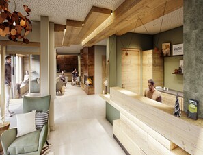 Ein modernes Interieur mit einer Rezeption, einer Sitzecke und einem Kamin.