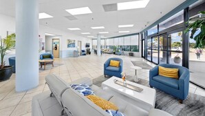 A spacious lobby with modern furniture, large windows, and a view of the outside. - Coastal Gulf Front Studio in Fort Morgan | Sleeps 4 (Gulf Shores)