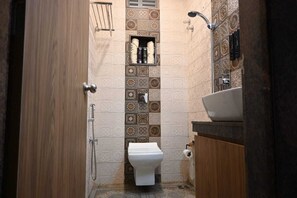 Towels, soap, toilet paper - "Relax. Recharge. Repeat," and "Luxury Redefined". (Chennai)