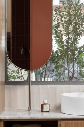 A bathroom with a large mirror, a white sink, and a potted plant. - Noemia Athens Near Acropolis Studio With Rooftop (Athens)
