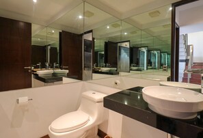 A modern bathroom with a toilet, sink, and large mirror. - w Upscale 2BR Duplex w Balcony in Miraflores (Lima)