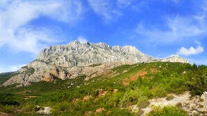 A mountainous landscape with rocky terrain and dense greenery. - Provencal village between Aix en Provence and Cassis (Fuveau)