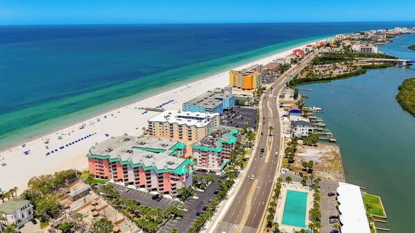 A coastal hotel with a beachfront view, multiple parking lots, and a road leading to the beach. - Recently renovated BEACH condo, tons of amenities (Indian Shores)