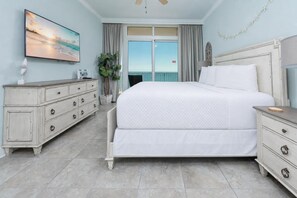A bedroom with a bed, dresser, and a large window with a view. - Phoenix Orange Beach 902 3 Bedroom Condo (Orange Beach)