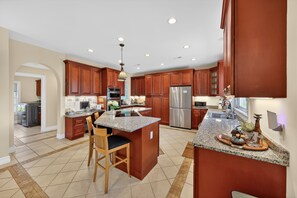 A spacious kitchen with granite countertops, stainless steel appliances, and wooden cabinetry. - Milford Quiet Coastal Retreat 3br Sleeps 8 3 Bedroom Home (Milford)