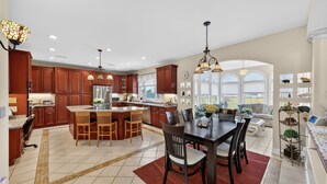 A spacious kitchen with wooden cabinets, a central island, and pendant lighting. - Milford Quiet Coastal Retreat 3br Sleeps 8 3 Bedroom Home (Milford)