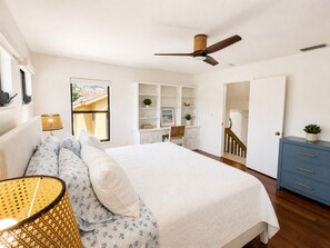 A bedroom with a bed, a desk, a chair, a wardrobe, and a ceiling fan. - Renovated 3/3.5 Pool home, Private Beach Access (Longboat Key)