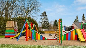 A playground with slides and climbing structures. - 40 Person Holiday Home in Skaerbaek (Skaerbaek)