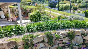 A stone wall with various plants and flowers. - STUDIO sea and cape view 2pers. (Erquy)