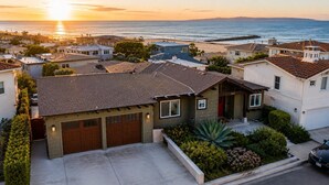 A residential area with houses, a garage, and a driveway. - 25% Off Sept WkDay Great 4 Families, Walk 2 Beach! (Ventura)