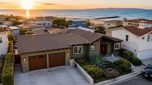 A residential area with houses, a garage, and a driveway.