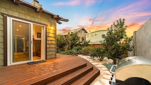 A patio with wooden steps, a barbecue grill, and a house with a sliding glass door. - 25% Off Sept WkDay Great 4 Families, Walk 2 Beach! (Ventura)