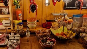 A buffet table with various food items and condiments.