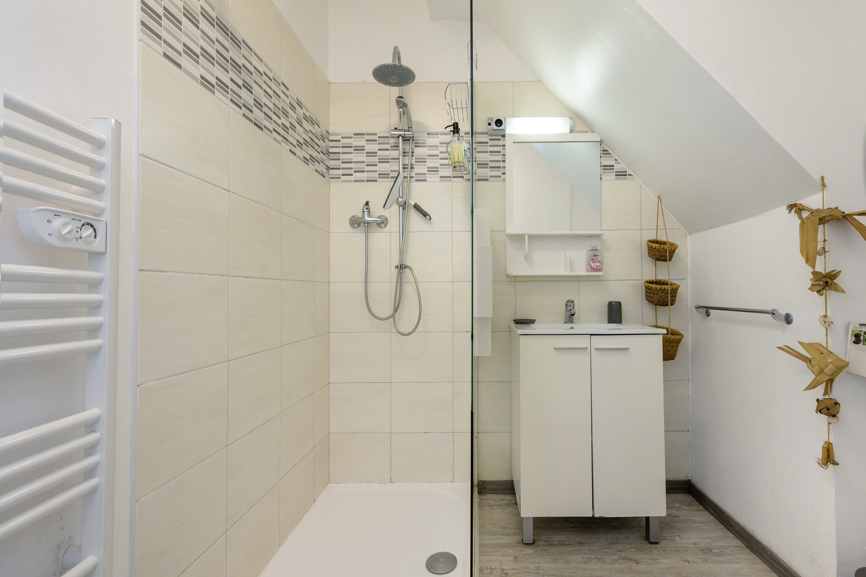 A modern bathroom with a shower, a toilet, and a sink.