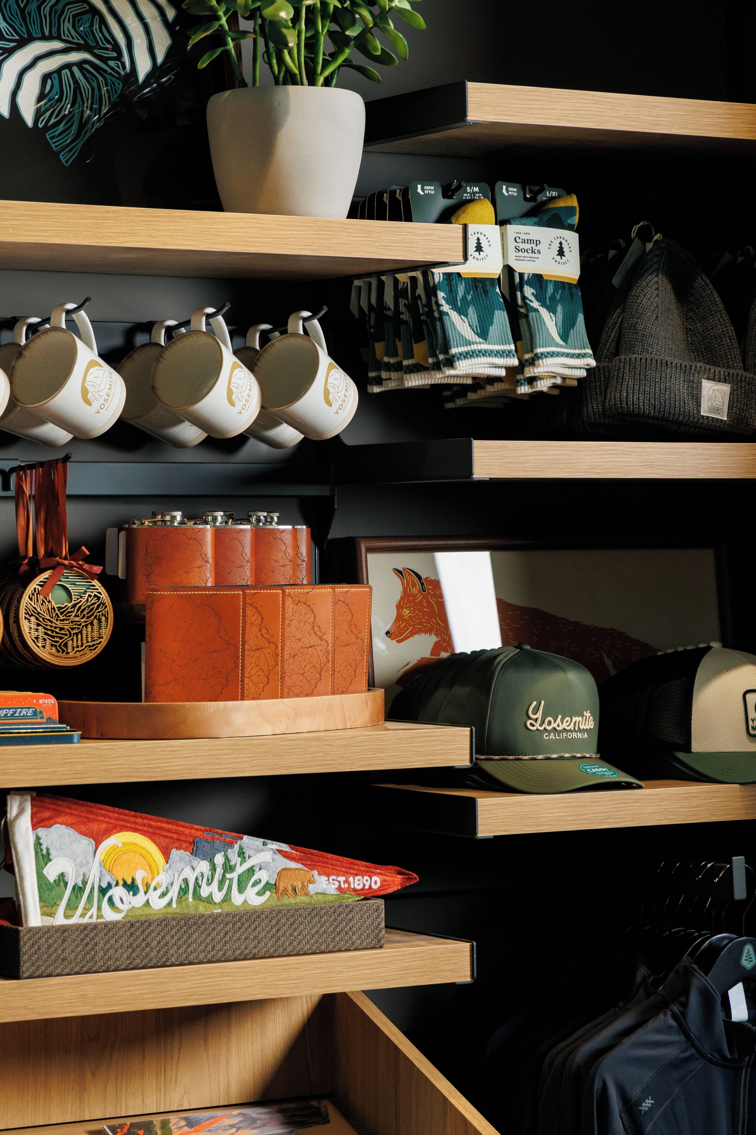 A retail display with various items including mugs, socks, and hats.
