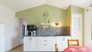 A kitchen with white cabinets, a microwave, a coffee maker, and a sink. - Holiday Home “L’Olivier - La Fontinelle” (Bessas)