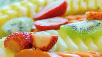 A variety of sliced fruits including strawberries, kiwi, and mango.