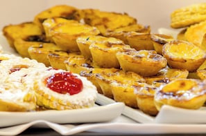 Una variedad de productos horneados, como pasteles y pan, sobre un plato blanco.