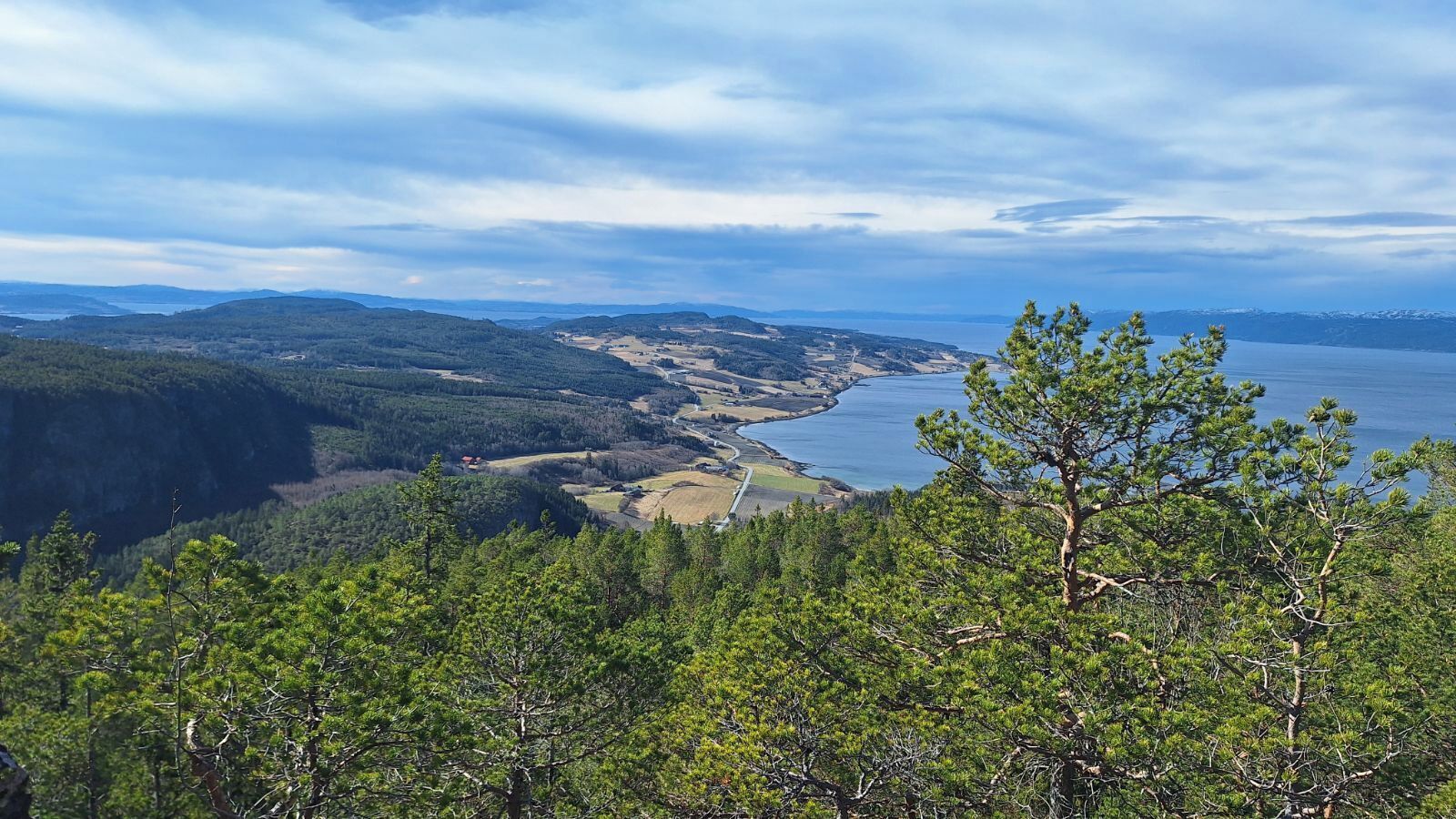 A mountainous landscape with a clear view of a lake and distant hills.