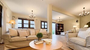 A living room with two sofas, a coffee table, and a bookshelf.