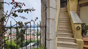 A staircase leading to a balcony with a view of a cityscape. - La Casa Bianca nel Borgo - by Be Your Home (San Felice Circeo)