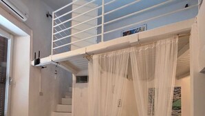 A room with a bunk bed, a staircase, a couch, and a bed. - La Casa Bianca nel Borgo - by Be Your Home (San Felice Circeo)
