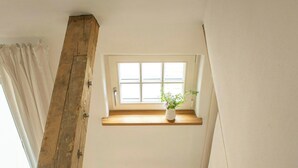 A wooden staircase with a window above. - Oasis of peace near the lake (Langen Jarchow)