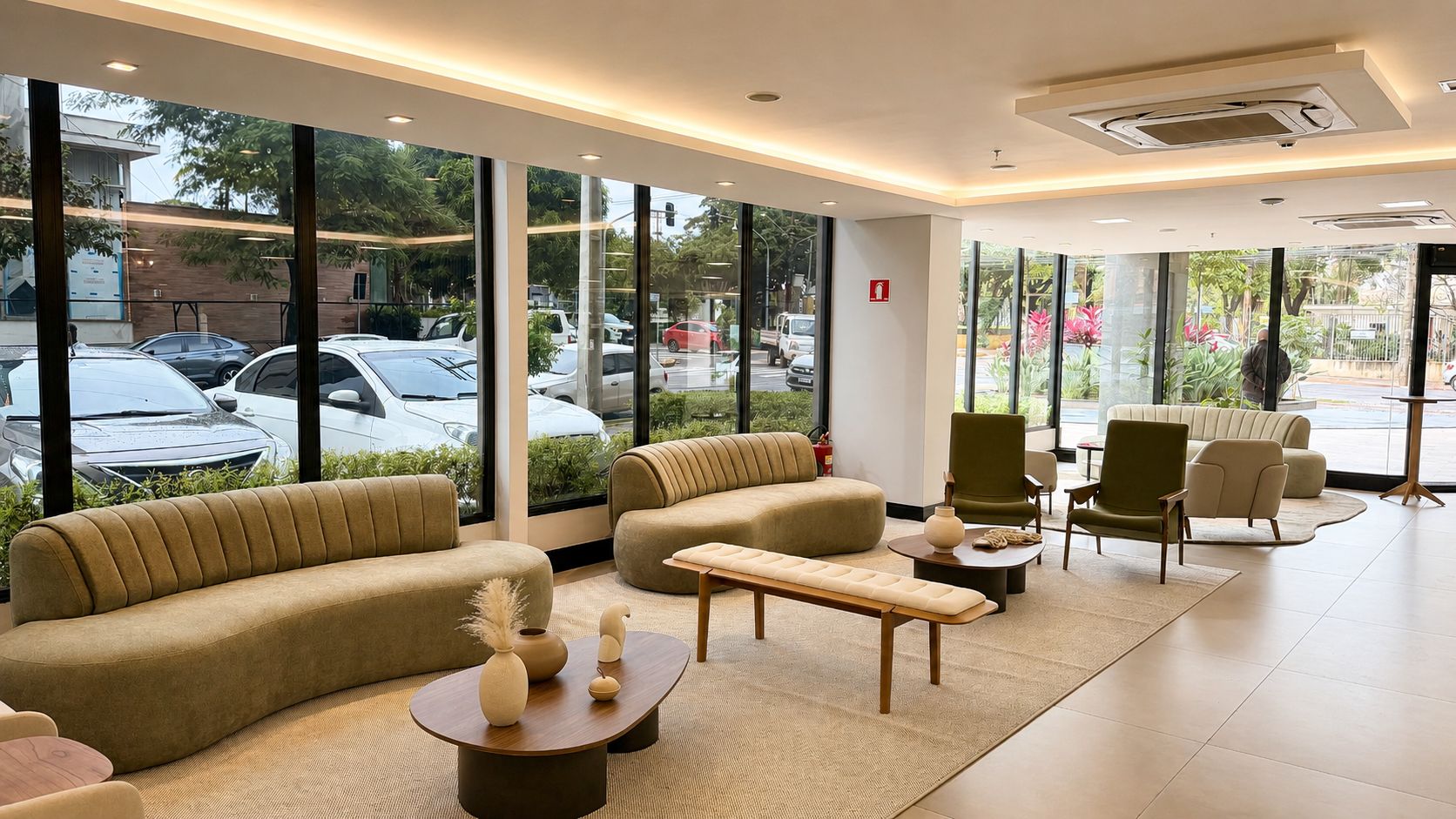 A modern hotel lobby with a sofa, chairs, a bench, and a coffee table.