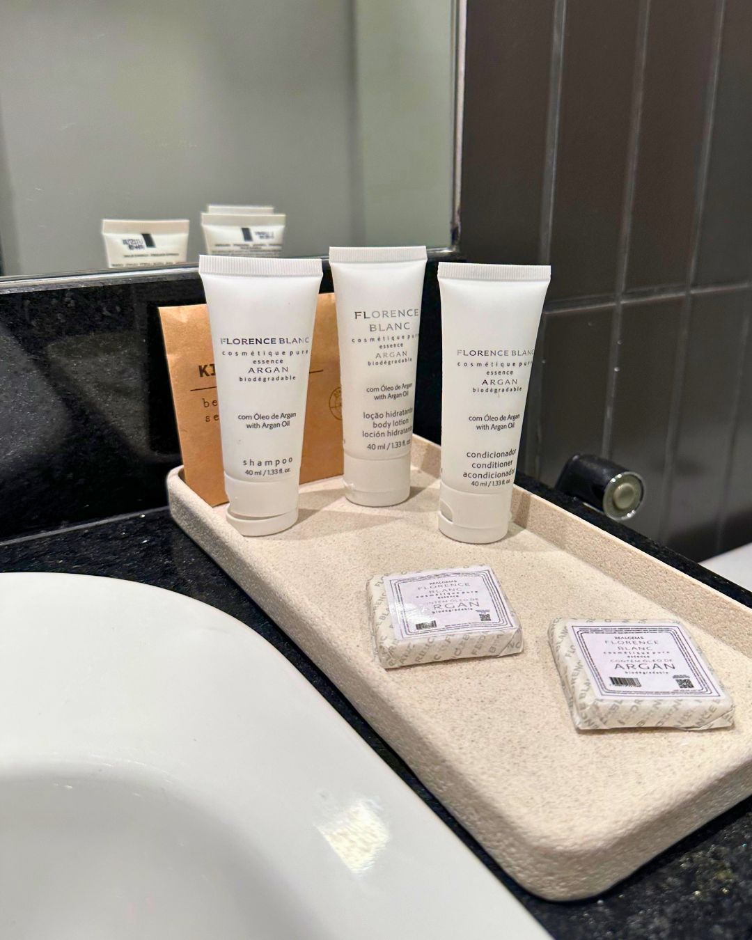 Toiletries on a countertop in a bathroom.