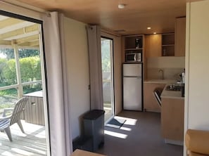 A compact kitchen with a refrigerator, microwave, and sink. - Camping 3 étoiles - Piscine  - ccbffde (Arces)