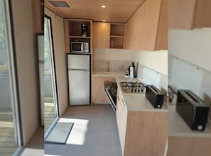 A compact kitchen with a refrigerator, microwave, stove, and sink. - Camping 3 étoiles - Piscine  - ccbffde (Arces)