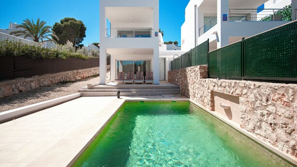 A modern two-story house with a swimming pool, stone walls, and a clear blue sky. - Villa Marina Blanca - elegance and tranquillity right on the harbor (Islas Baleares)