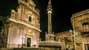 A historic building with ornate architecture, a prominent tower, and a well-lit facade. - Room 'Casa Sant'Anna 2' with Air Conditioning (Presicce)