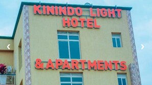 A building with signage for 'KININDO LIGHT HOTEL & APARTMENTS'. - Kinindo Light Hotel (Bujumbura)