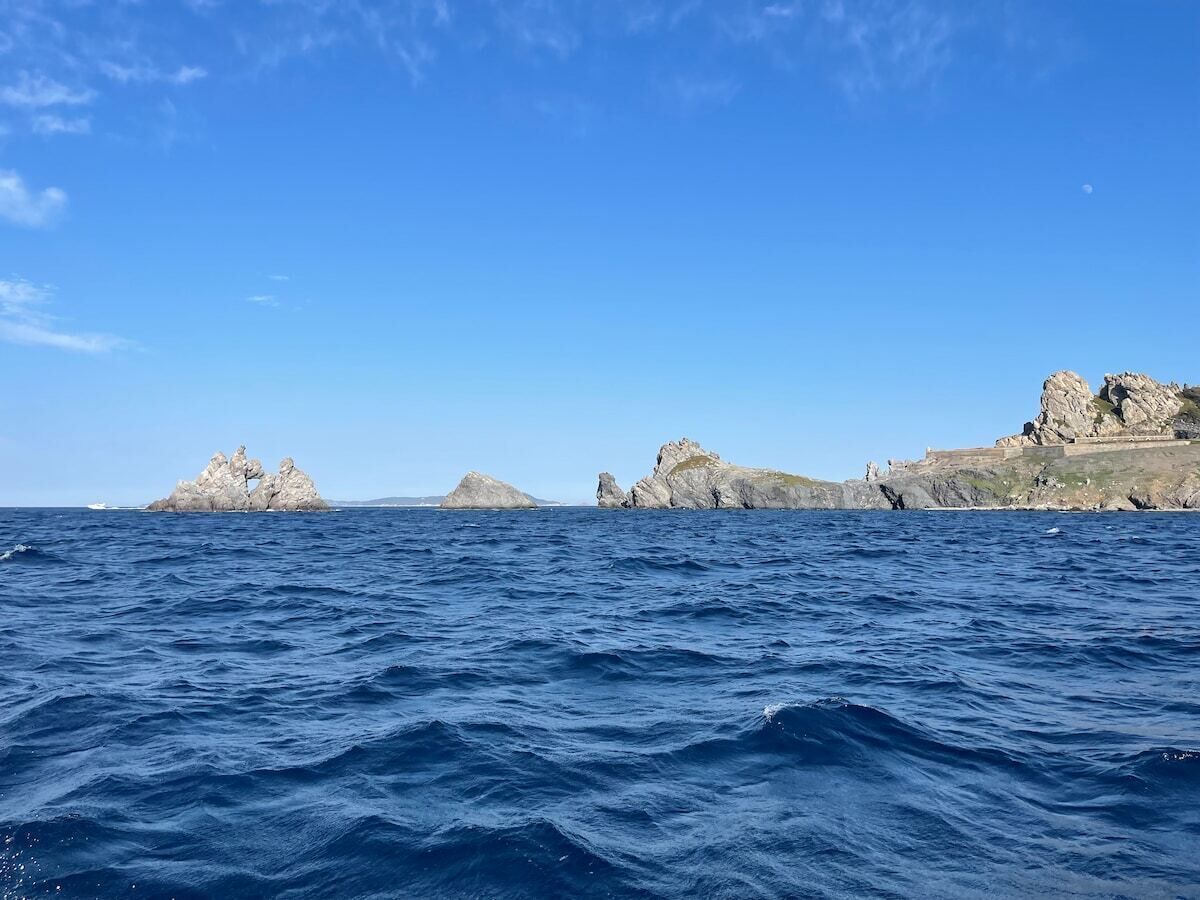 A coastal scene with rocky outcrops and calm sea.
