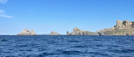 A coastal scene with rocky outcrops and calm sea.